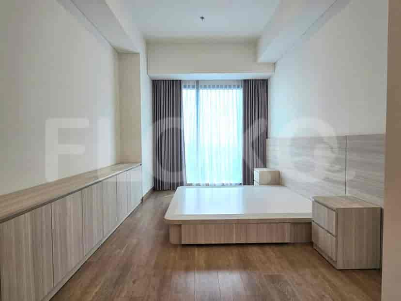 Spacious bedroom with wooden flooring and modern design.