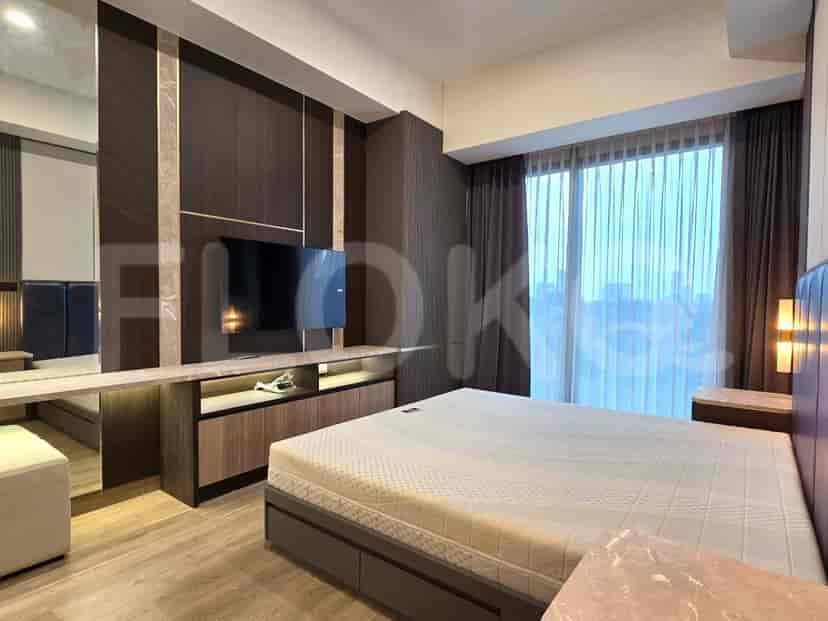Modern bedroom with a king-sized bed, a large window, and built-in TV.