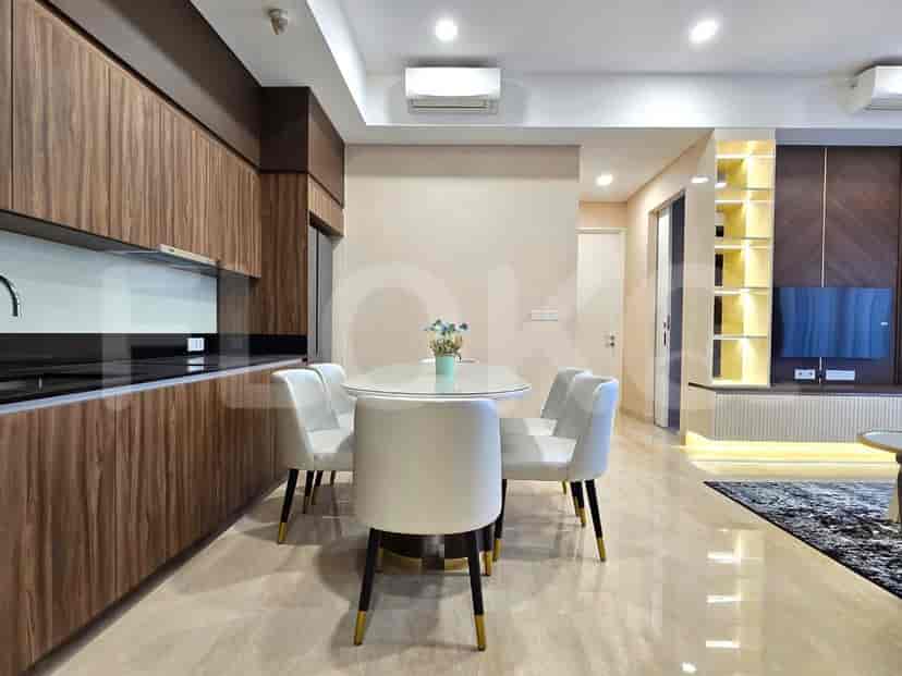 Modern kitchen with wooden cabinetry and a dining area.