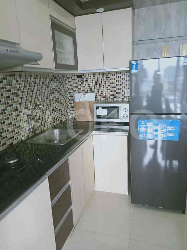 Modern kitchen with stainless steel appliances and wooden cabinetry.