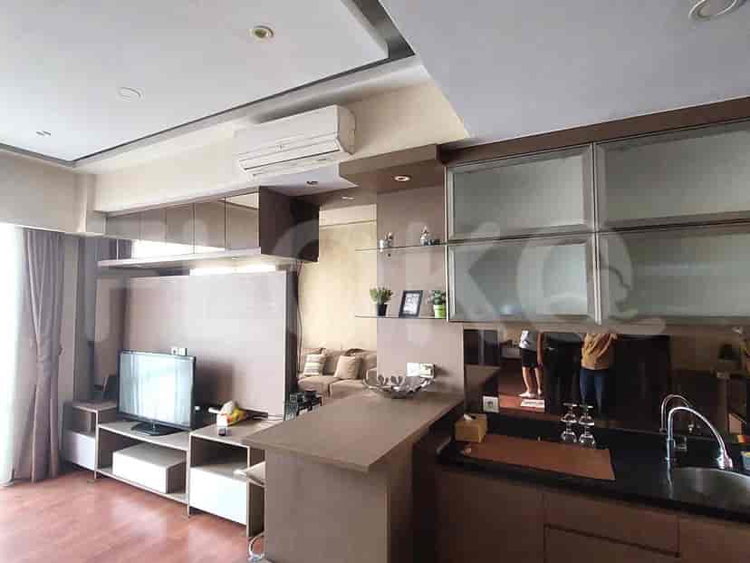 Modern kitchen with an island, built-in cabinets, and a black countertop.