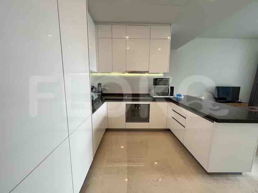 Modern kitchen with white cabinets, black countertops, and built-in appliances.