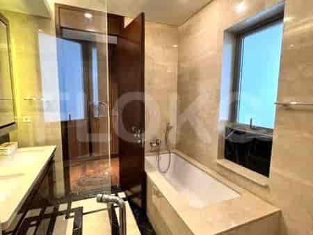 Elegant bathroom with a bathtub, window, and modern fixtures.