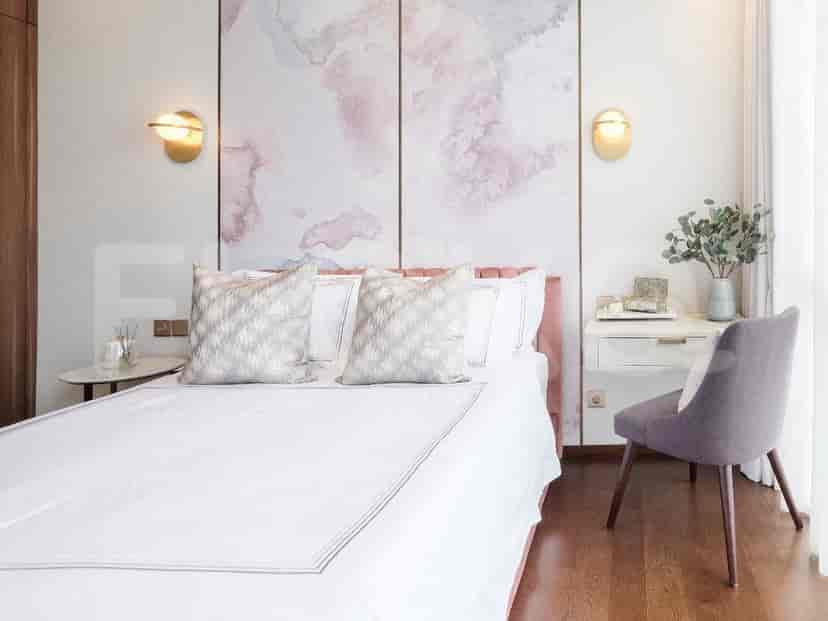 A modern bedroom with a double bed, desk, and floral accents.