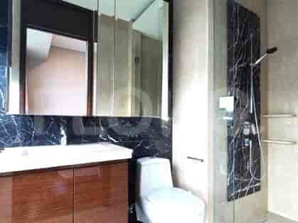 A modern bathroom featuring a vanity with a mirror, a toilet, and a shower.