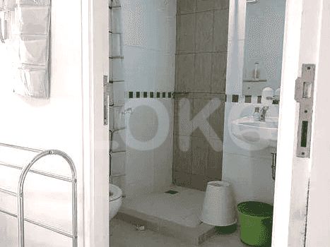 A bathroom featuring a toilet, sink, and shower area.