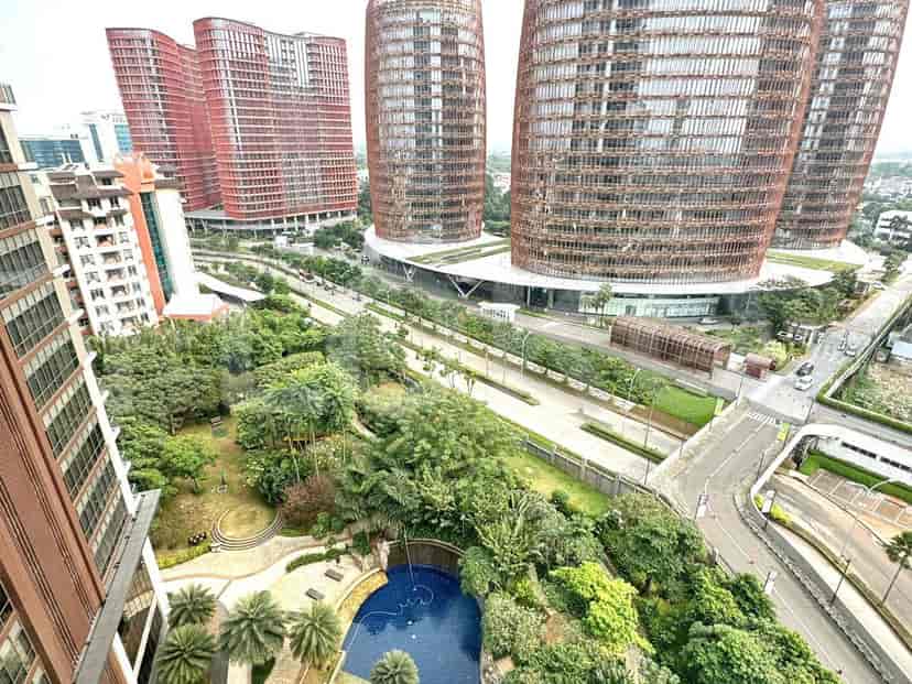 Stunning city views with modern high-rise buildings, green spaces, and a swimming pool.