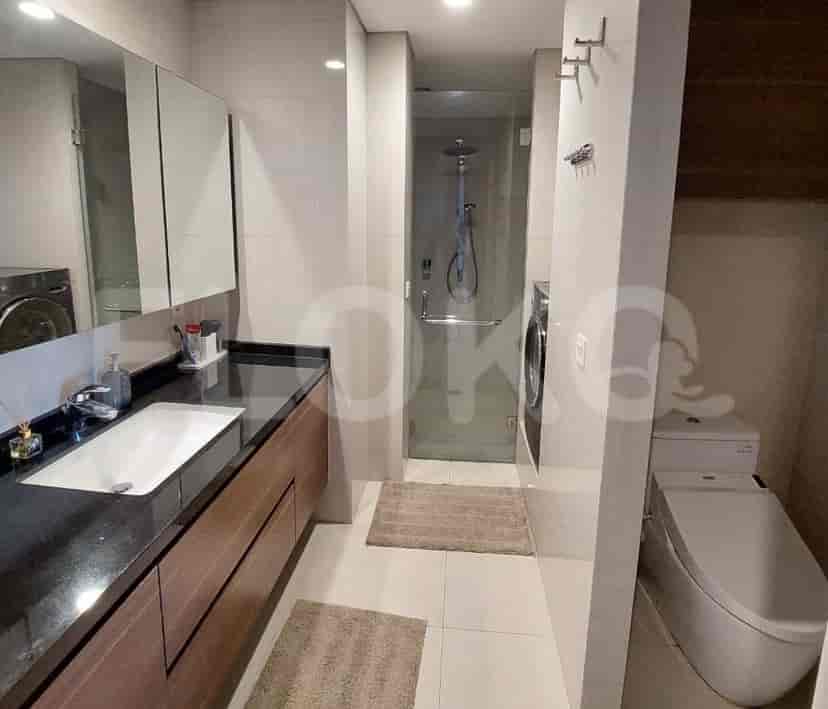 A bathroom with a shower, sink, and toilet.