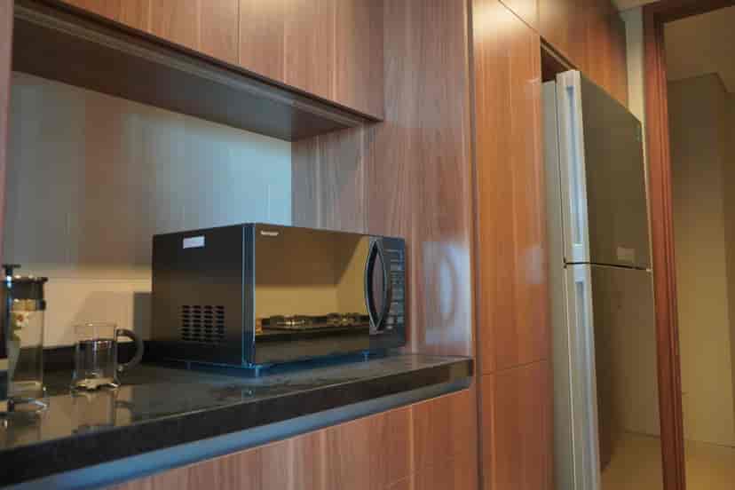 Modern kitchen with a microwave and cabinets.