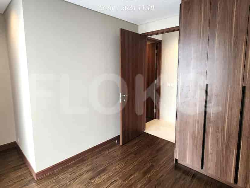 Bedroom with closet and wooden flooring.