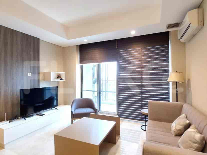 Modern living room with TV, sofa, and window.