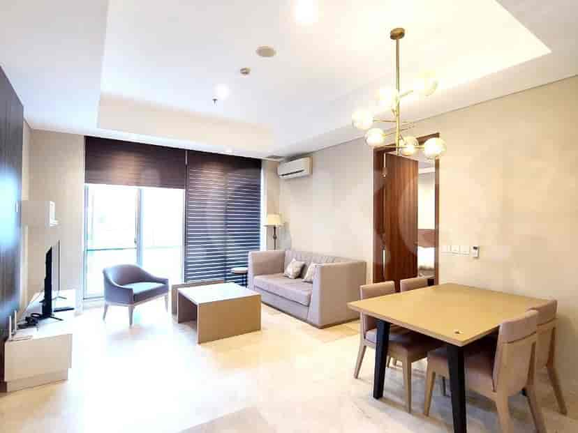 Living and dining area with modern furniture and marble flooring.