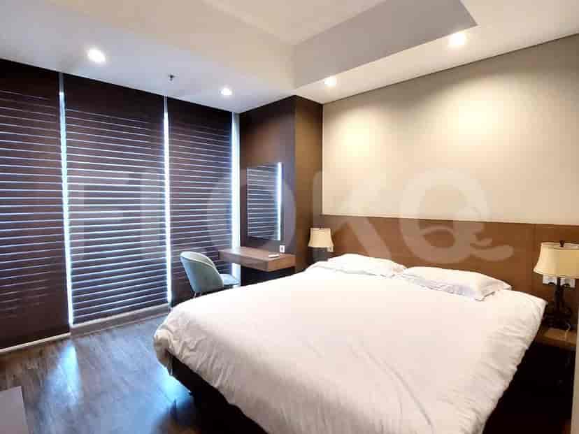 Bedroom with a bed, desk, and blinds.
