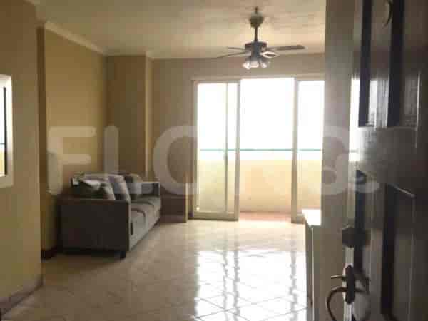 Another view of the living room with sofa and access to balcony.