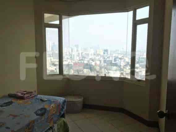 Bedroom with a bed, large window, and city view.