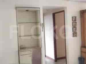 A hallway opens into a room with cabinets and shelving.