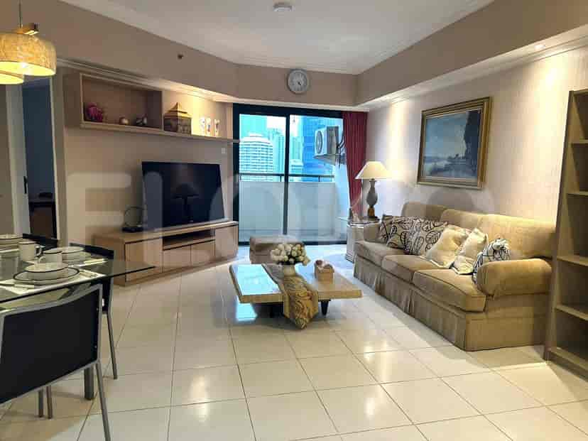 Living room with a sofa, TV, and city view.