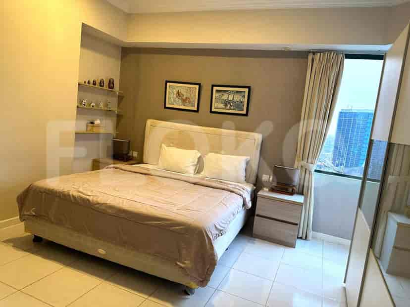 Bedroom with a large bed and city views.