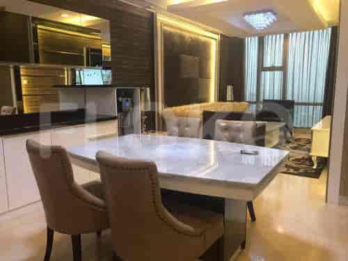 A modern dining area featuring a marble table with seating for four, integrated into a luxury apartment.