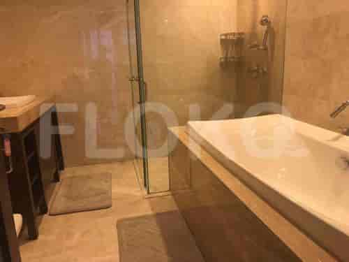 Luxurious bathroom with a large bathtub, glass shower, and elegant tile work.