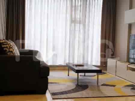 Living room with sofa, rug, and curtains.