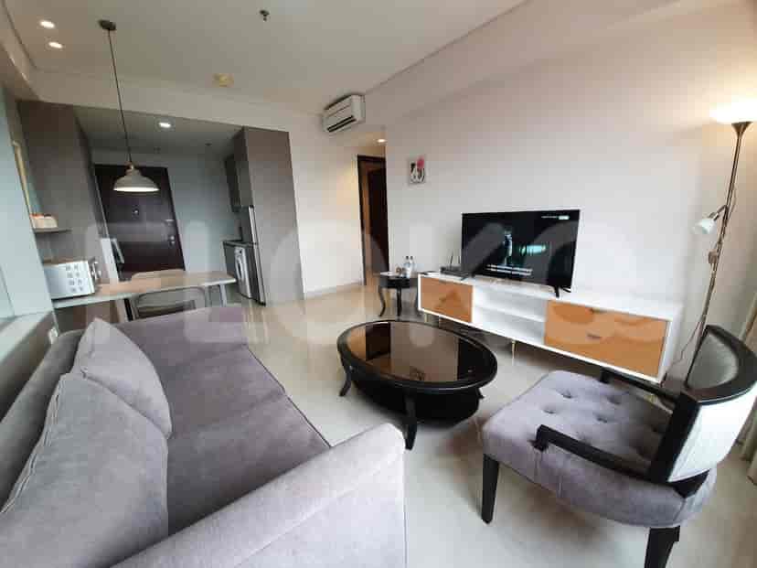 A living room featuring a sofa, smart TV, and modern furnishings.