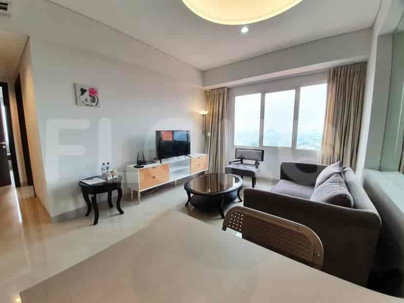 A living area with a sofa, chair, and table.