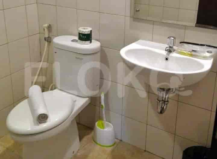 A bathroom with a toilet and sink.