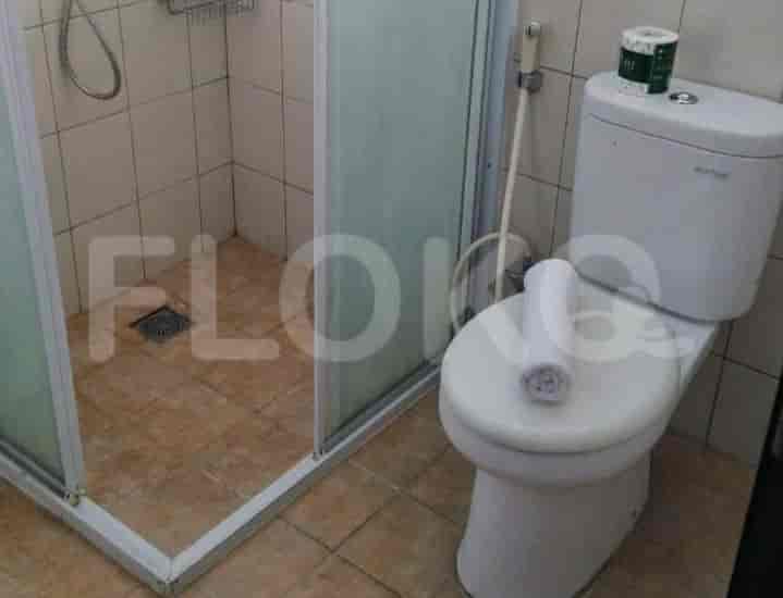 A clean bathroom with a toilet and shower.
