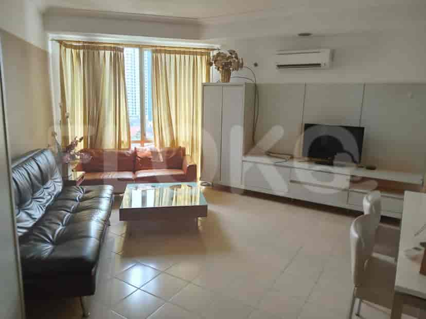 Living room with a sofa, coffee table, and TV console.