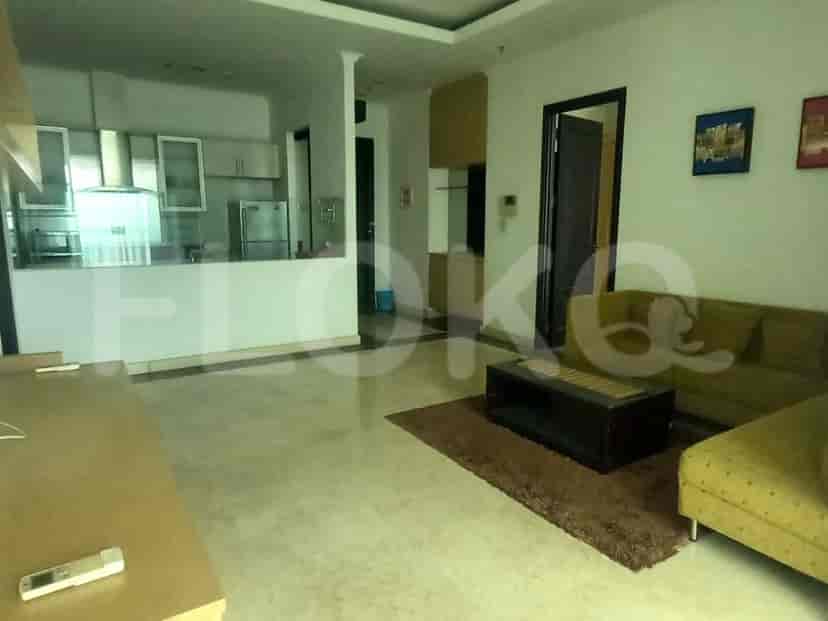 Spacious living area with open kitchen, comfortable seating, and a neutral color palette.