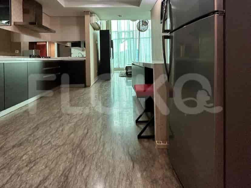 A modern kitchen with a stainless steel refrigerator.