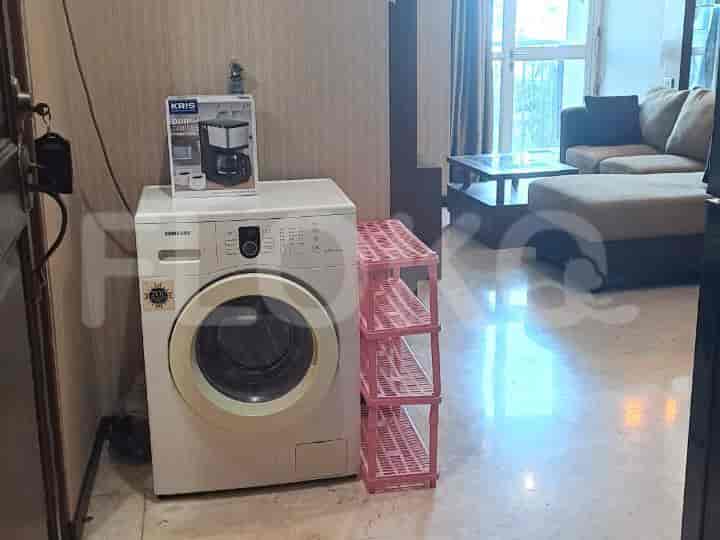 A small laundry area with a washing machine and a coffee maker.