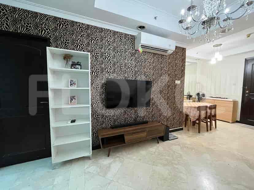Living room with zebra-striped wallpaper, TV, and chandelier.