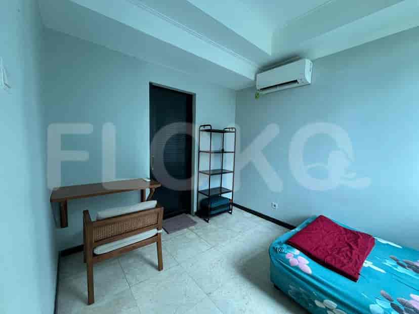 Bedroom with a desk, single bed, and air conditioning unit.