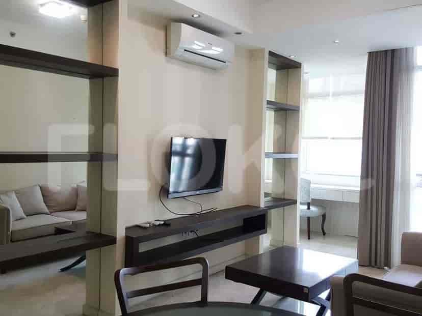 A living room with a TV and sofas.