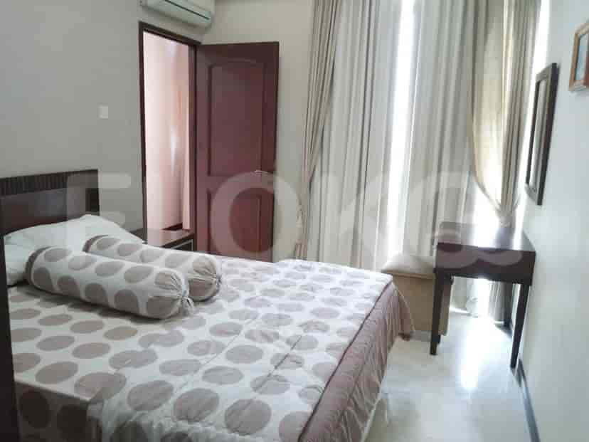 Bedroom with a double bed, side table, and window.