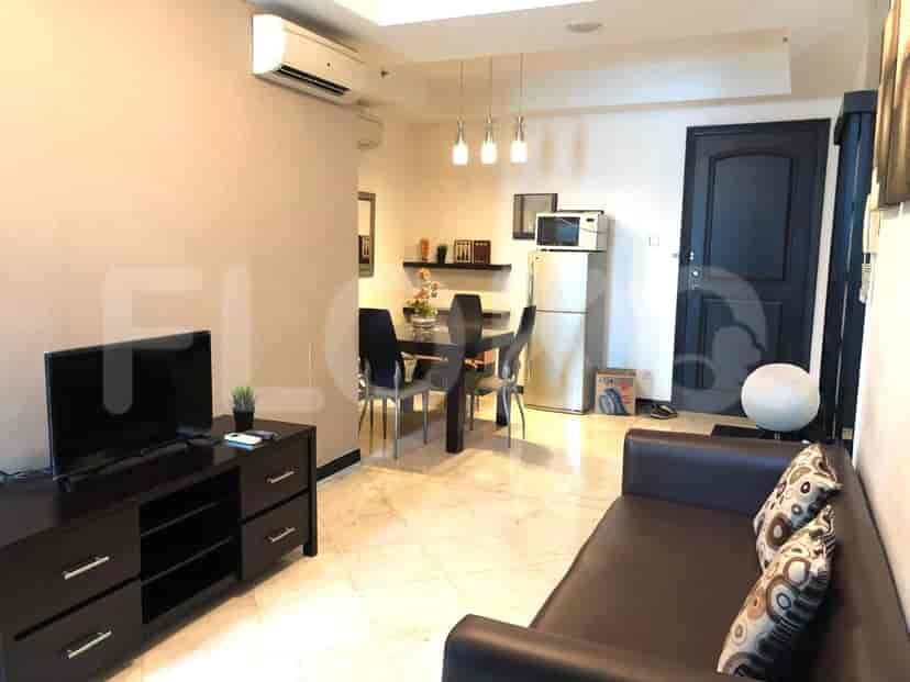 Living room with dining area, kitchen appliances, and a sofa.