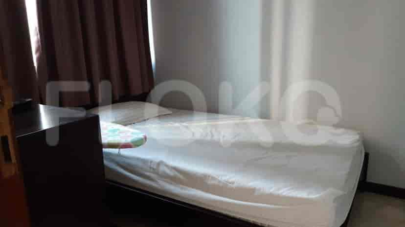 A small bedroom with a bed.