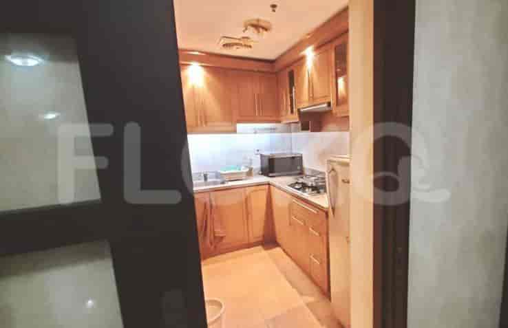 A kitchen with wooden cabinets and a gas stove.
