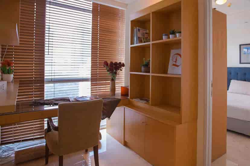 Home office area with desk and bookshelf.