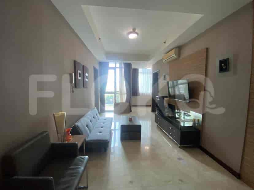 A modern living room featuring a grey sofa, a TV, and a coffee table.