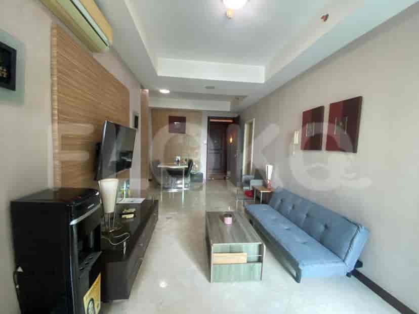 A living room with a sofa, a TV, and a coffee table.