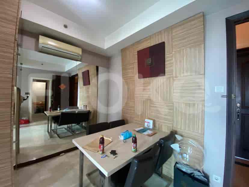 A dining room with a table, a mirror, and a painting.