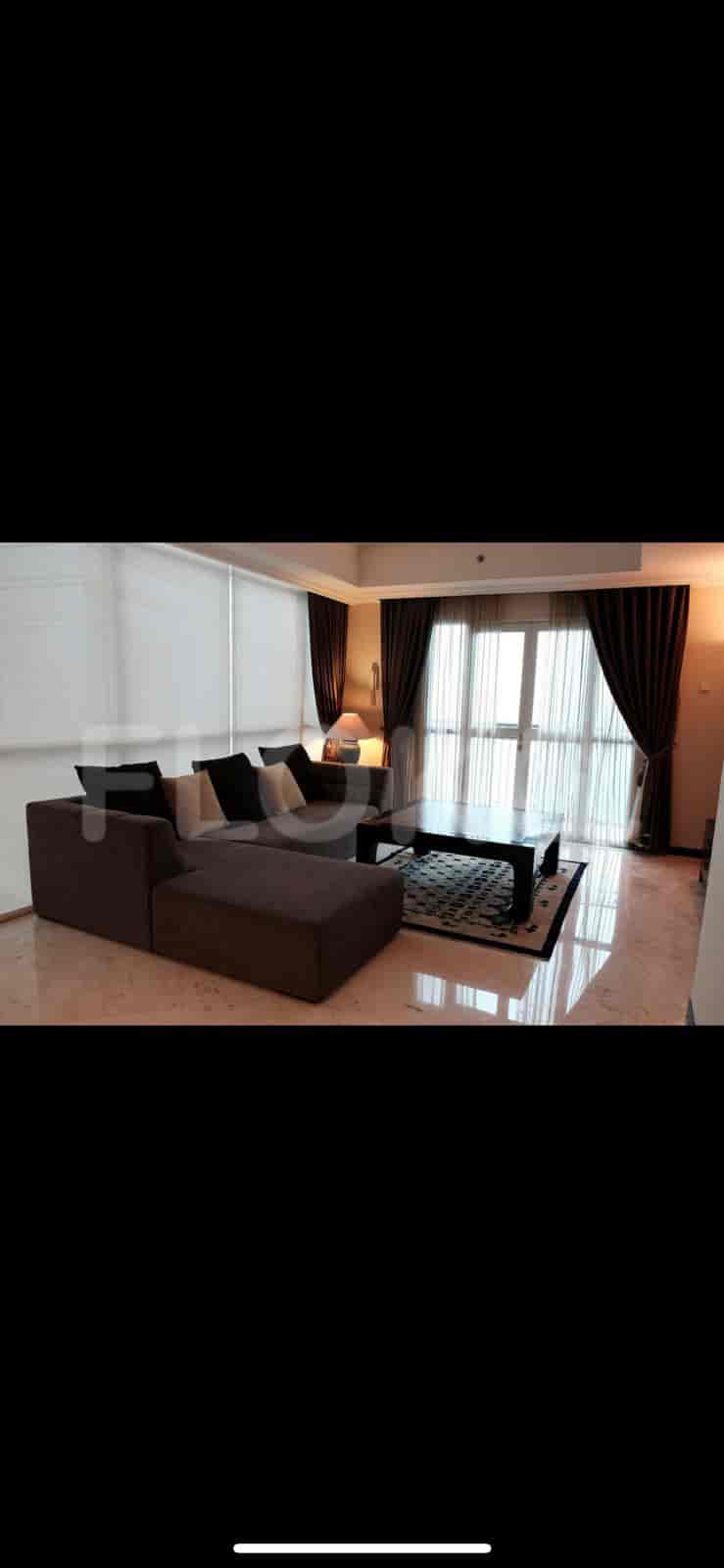 A modern living room with an L-shaped sofa and a city view.