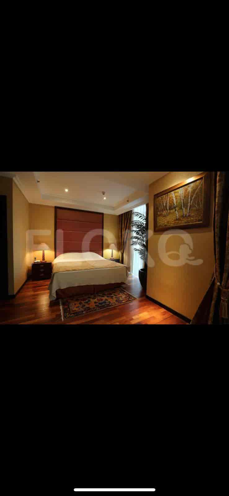 A stylish bedroom with a king bed, nightstands, and a scenic view.