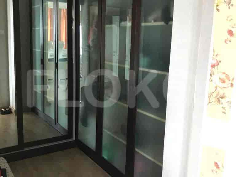 A closet with mirrored doors.