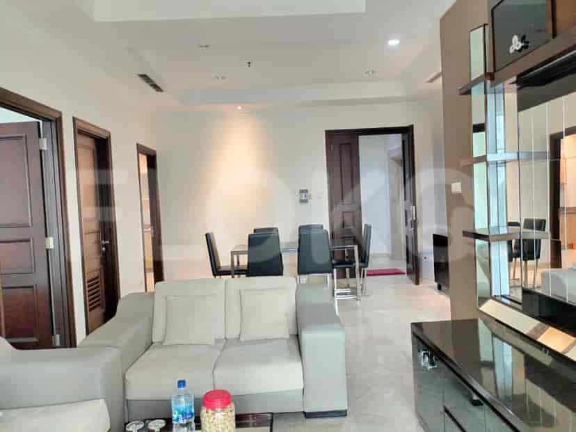 Spacious living area with a grey sofa, dining set, and marble flooring.