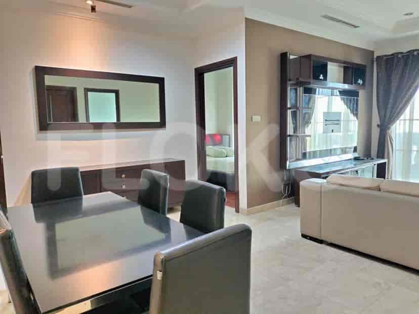 Living area with dining set, sofa and entertainment unit.