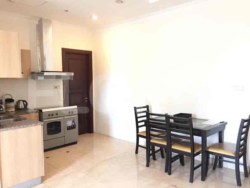 A kitchen with a dining table and chairs, cabinets, and appliances.